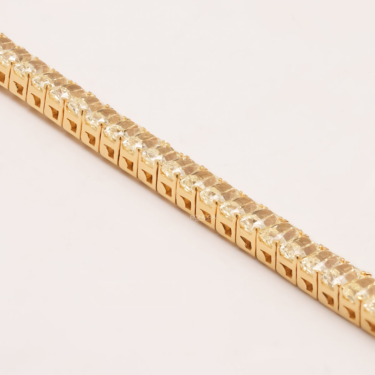 Side detail of radiant yellow lab grown diamond tennis bracelet