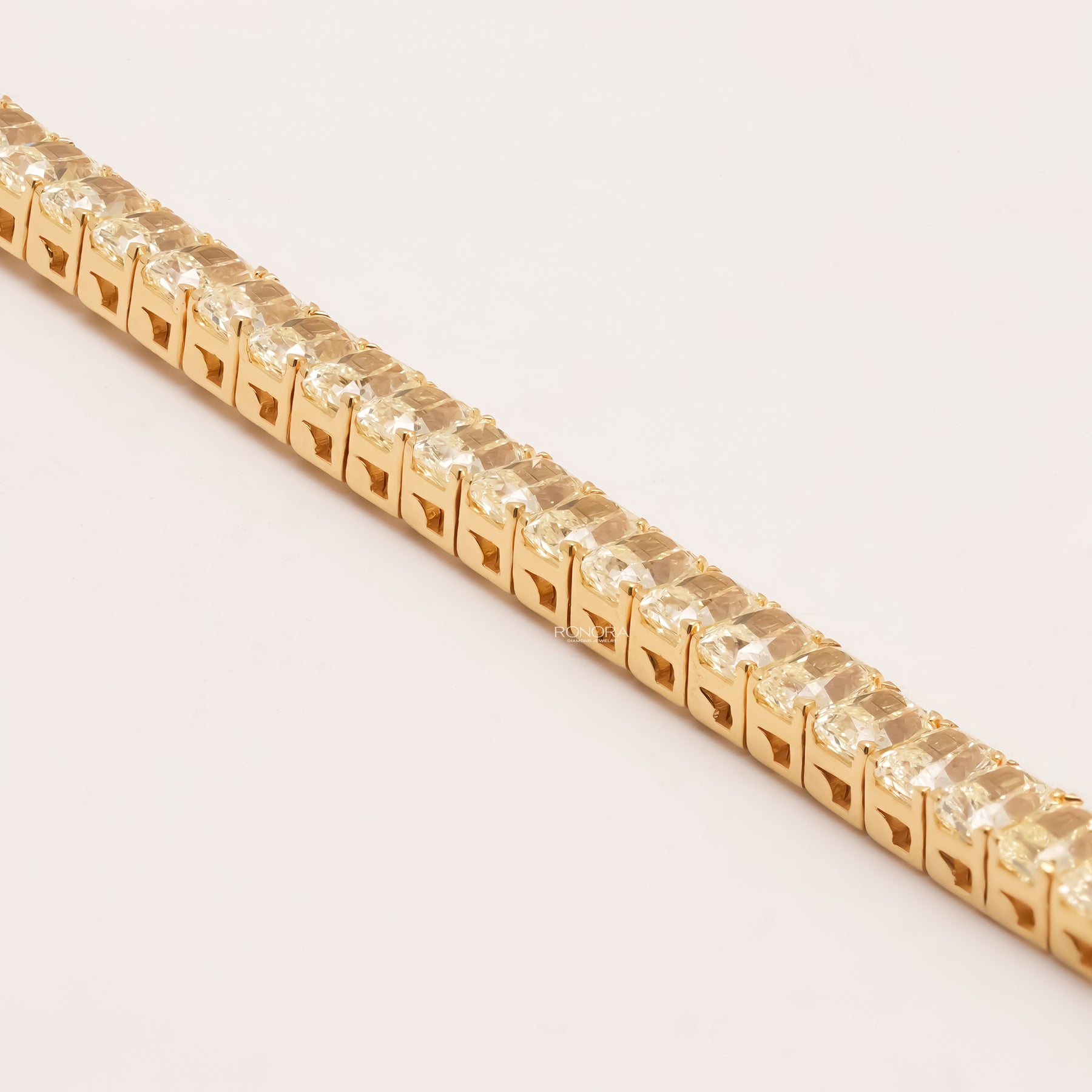 Side detail of radiant yellow lab grown diamond tennis bracelet