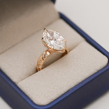 marquise lab grown diamond vintage halo ring worn on hand in yellow gold