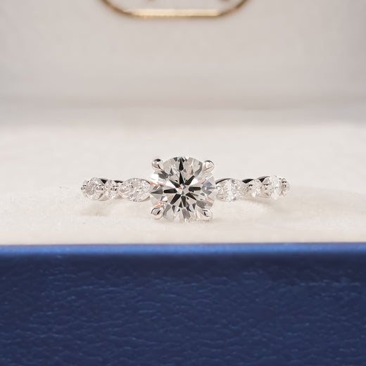 Isabelle round lab grown diamond side-stone ring in white gold inside Ronora box