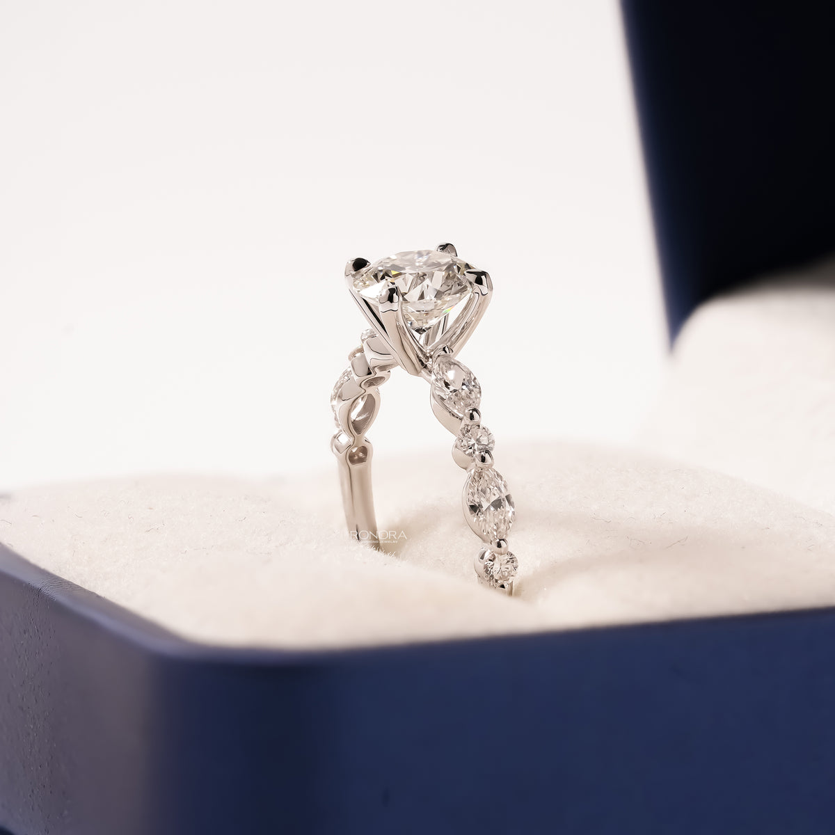 round lab grown diamond side-stone ring worn with luxury styling in white gold