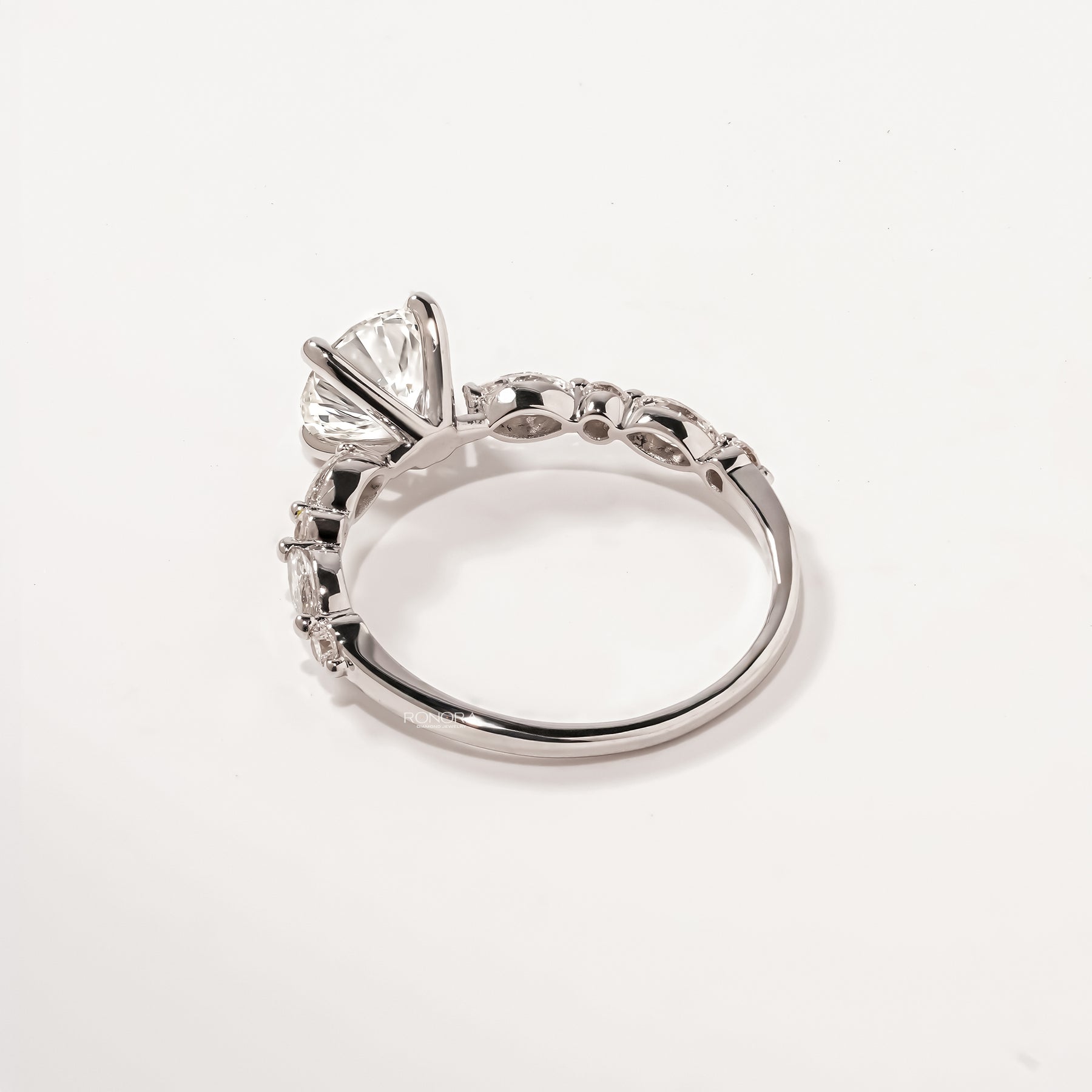 Back view of round lab grown diamond side-stone ring showing band detail