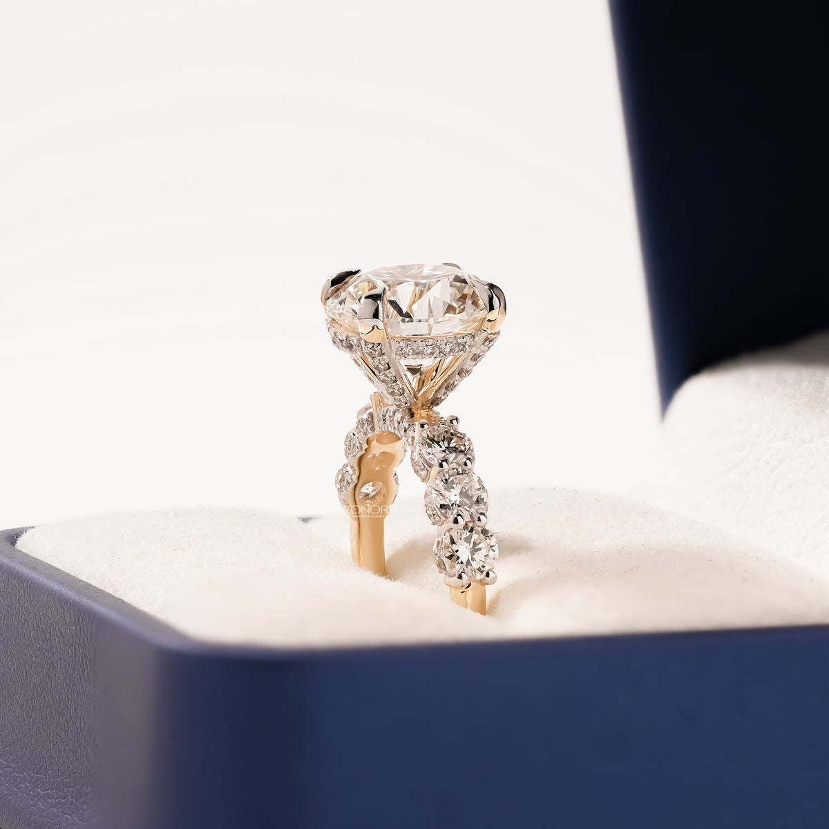 round lab grown diamond vintage halo ring worn with luxury styling in yellow gold