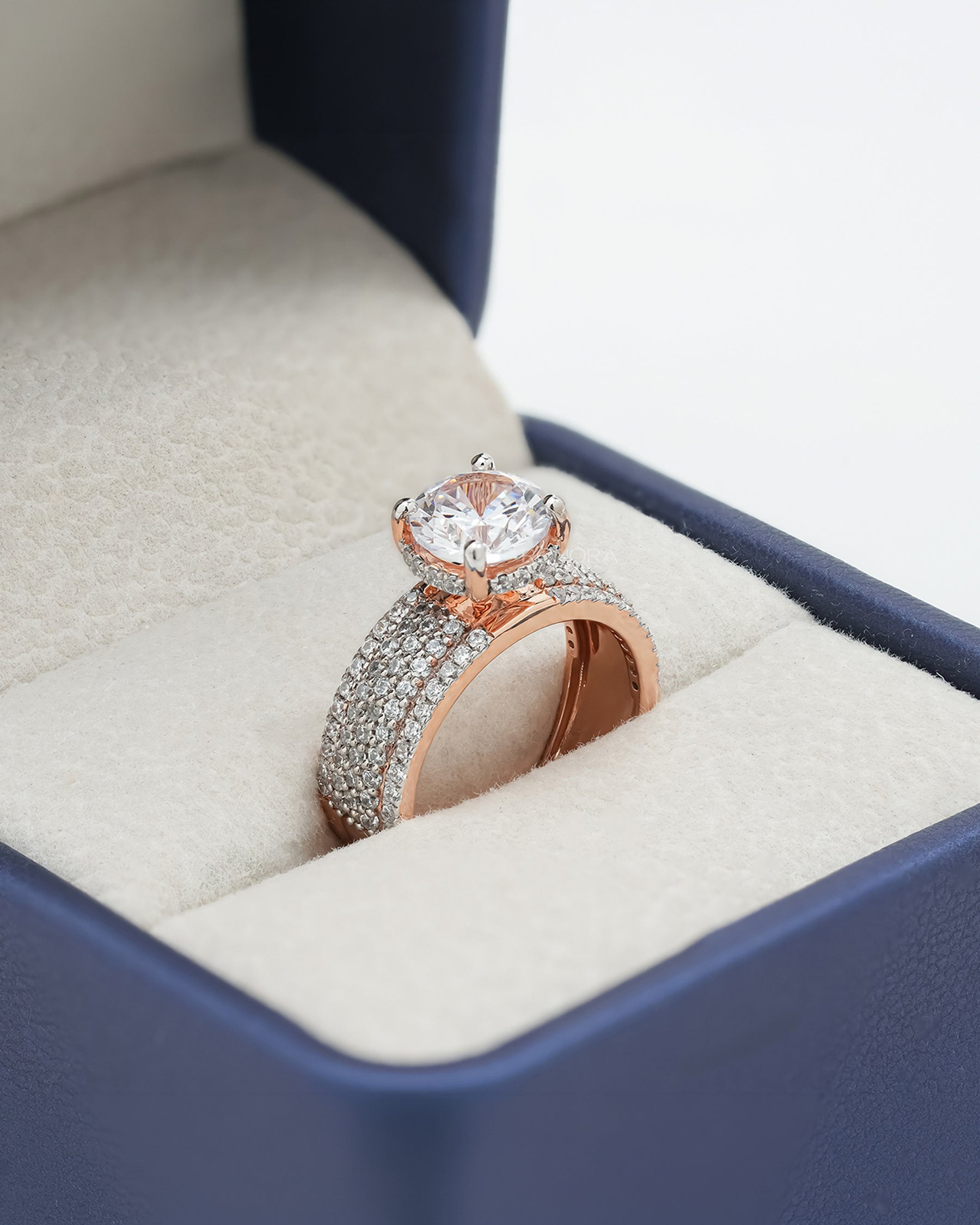 Angled view of round moissanite pave ring with pave setting