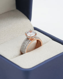 Angled view of round moissanite pave ring with pave setting
