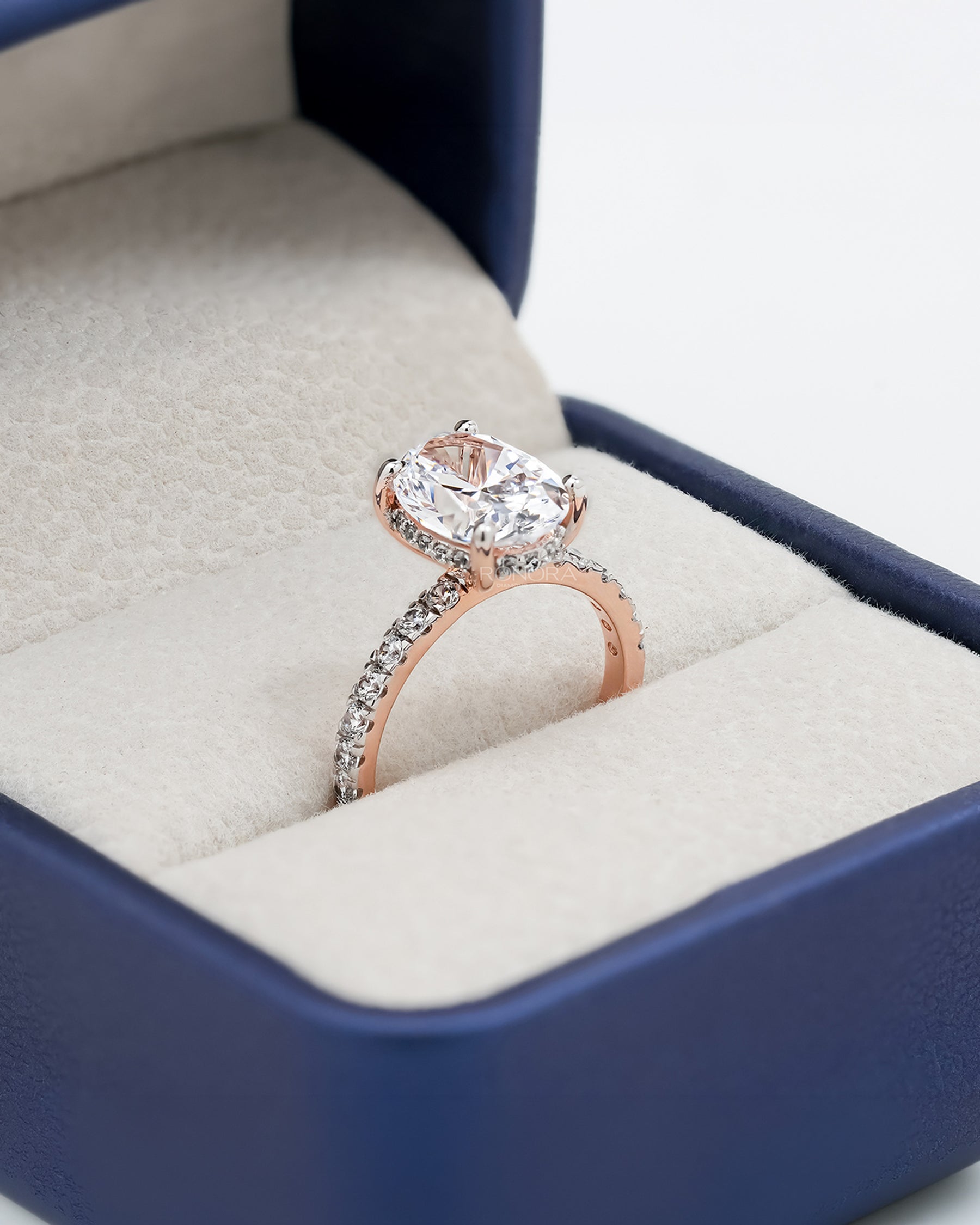 Angled view of oval moissanite pave ring with pave setting