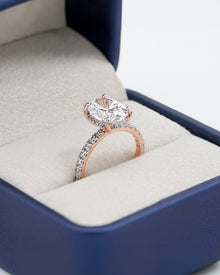 Angled view of oval moissanite pave ring with pave setting