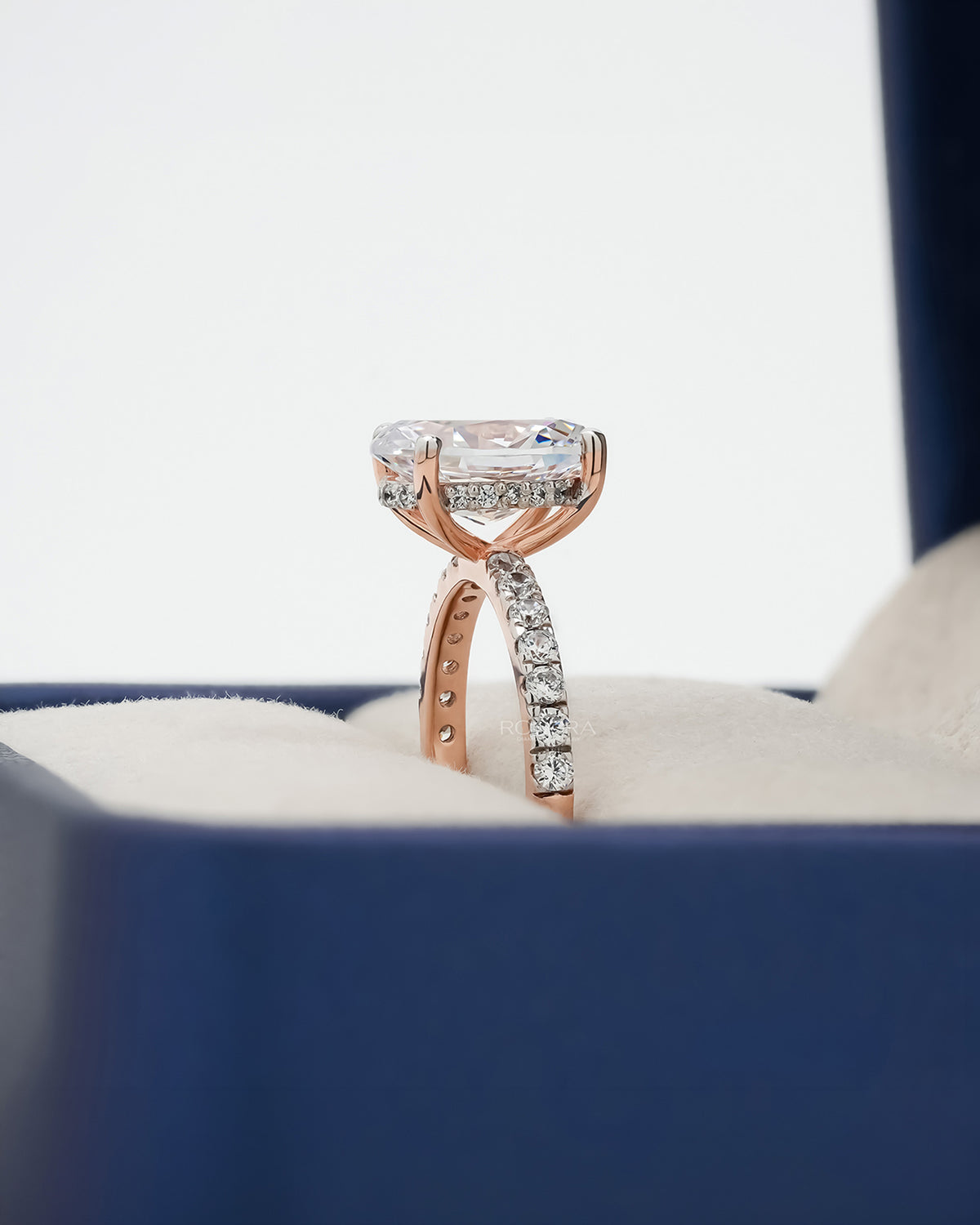 Side profile of oval moissanite pave ring showing ring setting
