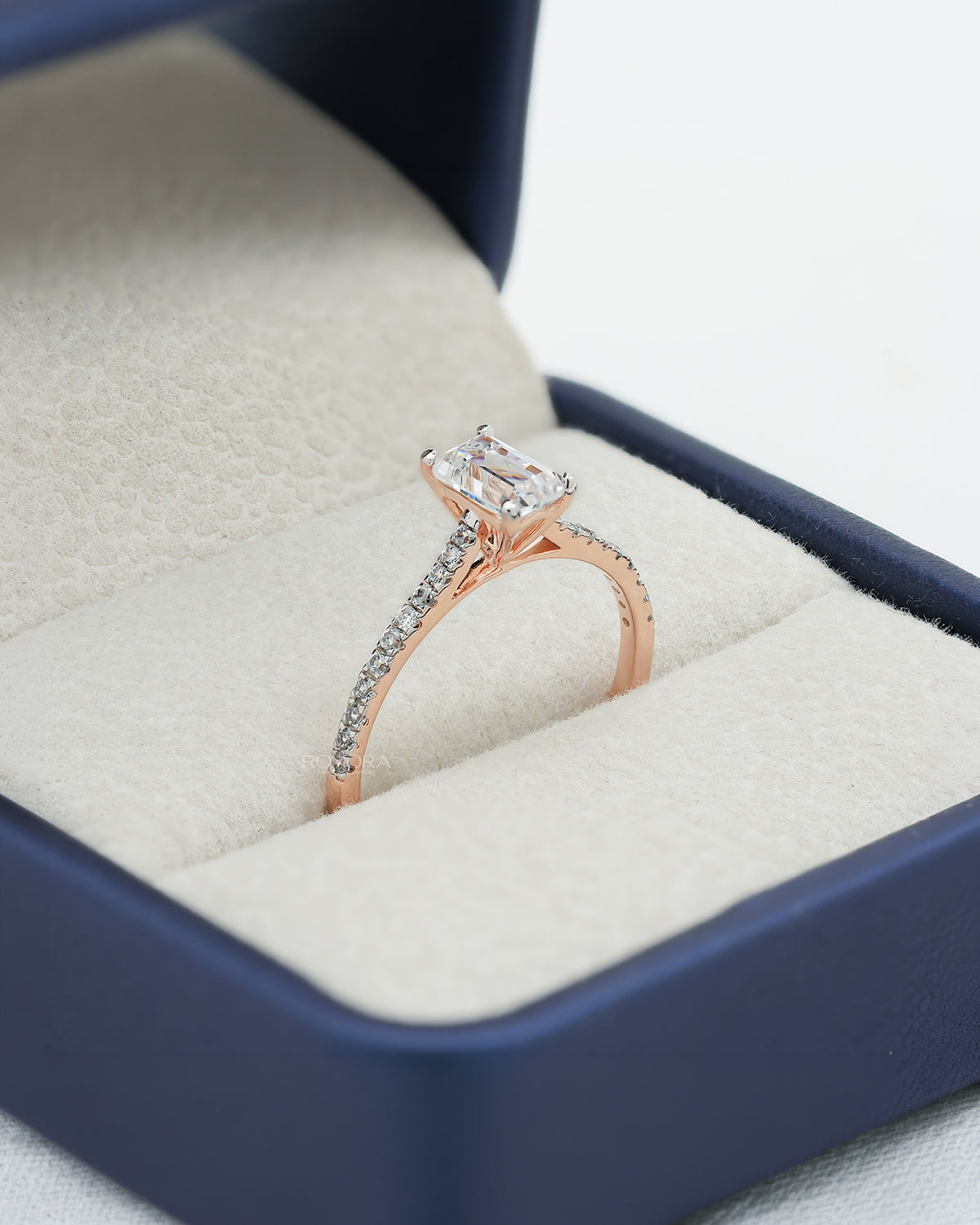 emerald cut moissanite pave ring worn with luxury styling in rose gold