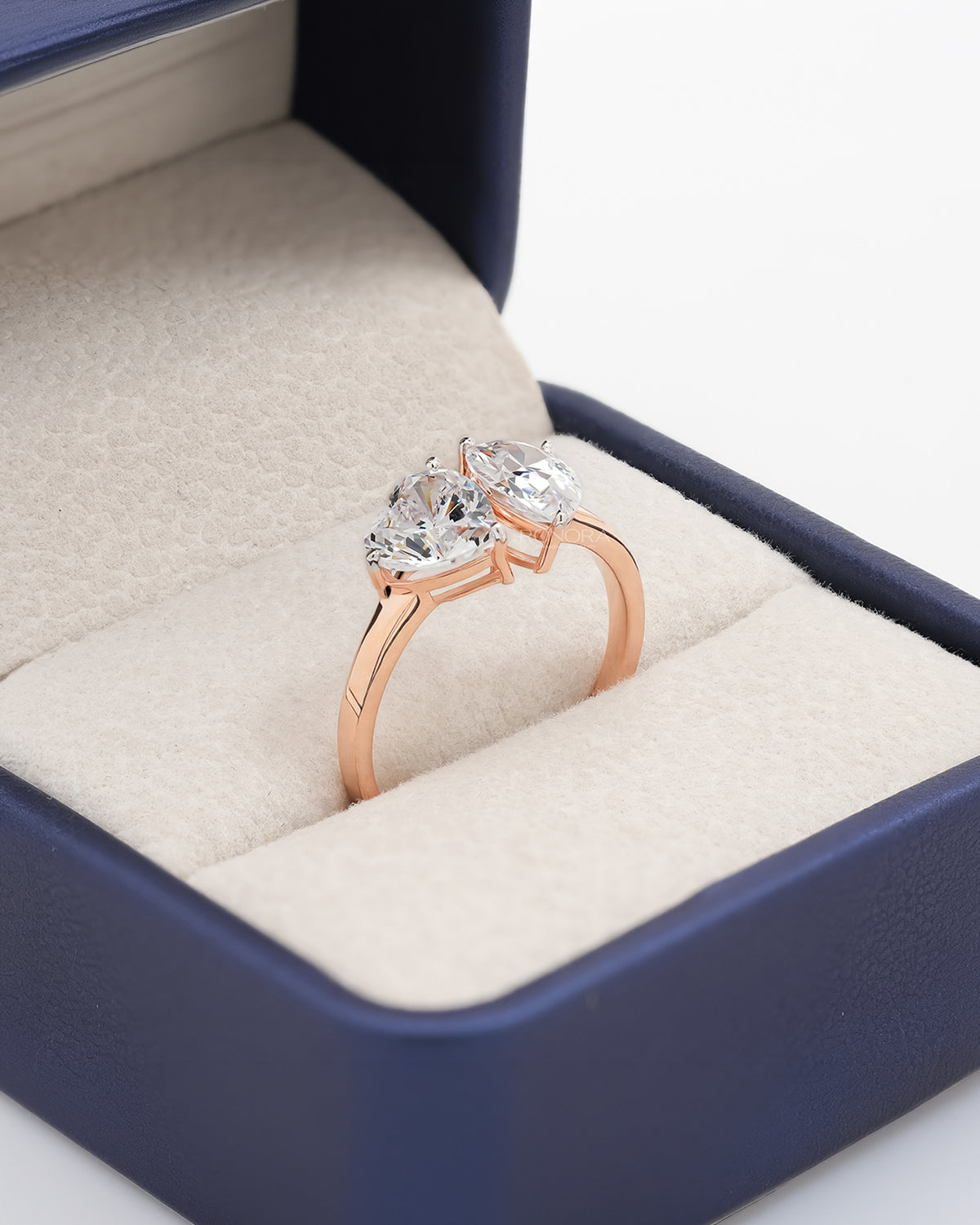 Angled view of heart pear moissanite toi et moi ring with toi et moi setting