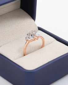 Angled view of heart pear moissanite toi et moi ring with toi et moi setting