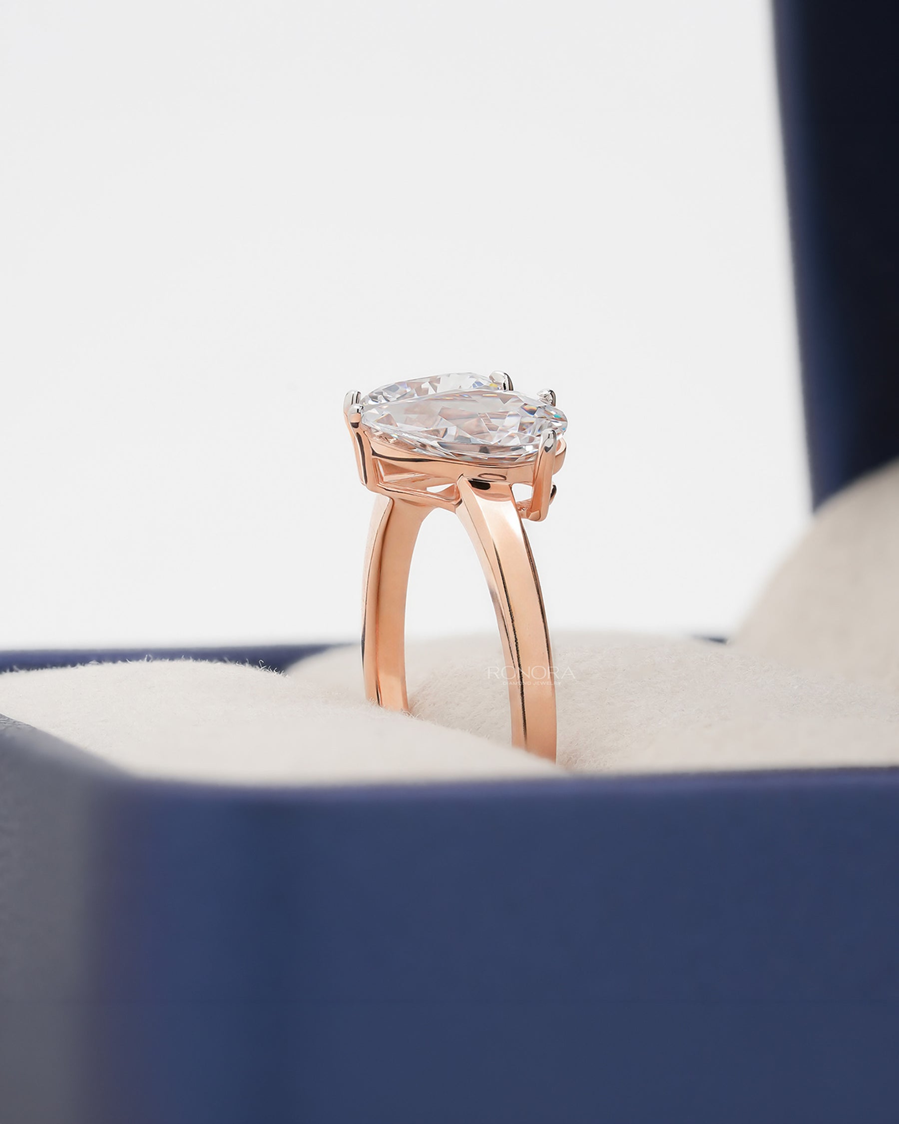 Side profile of heart pear moissanite toi et moi ring showing ring setting