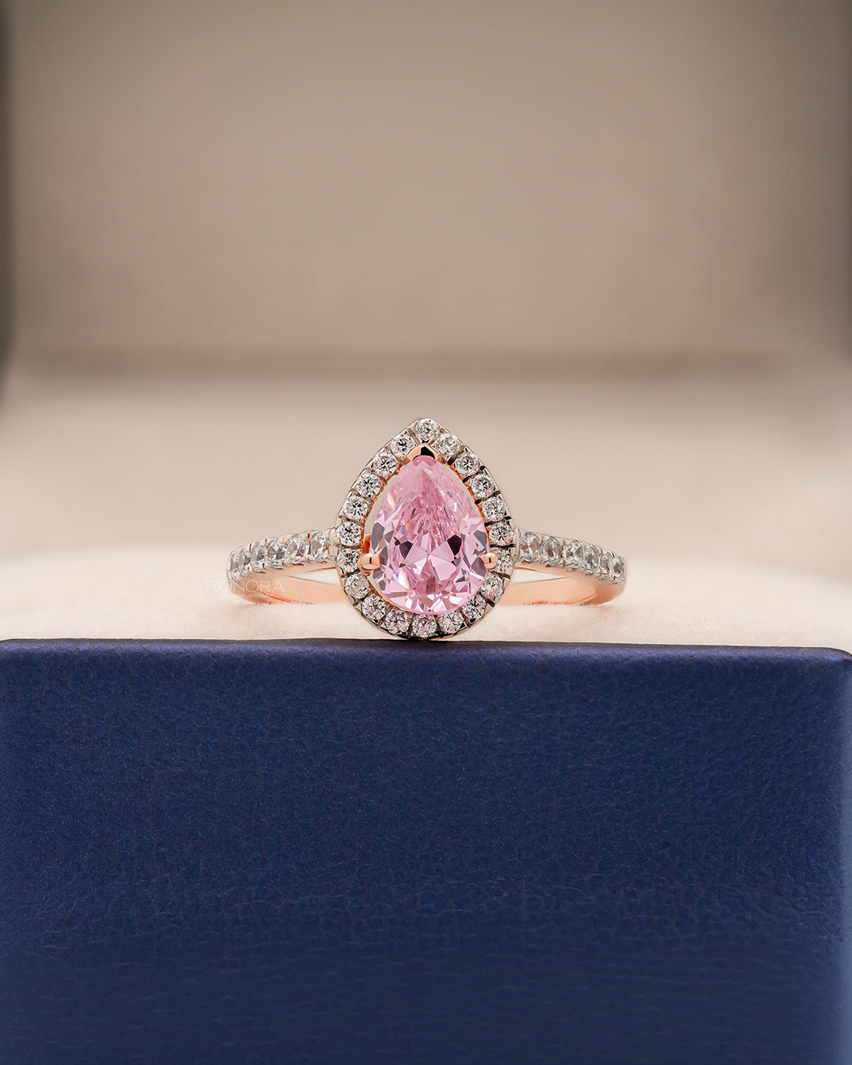 Livia pink pear moissanite halo ring in rose gold inside Ronora box