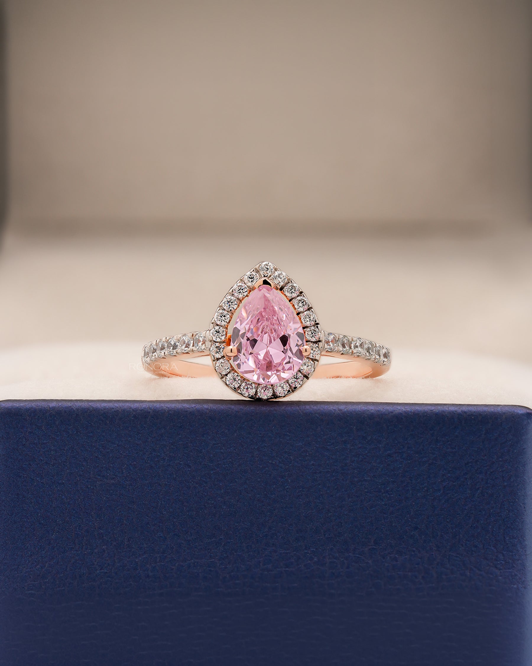 Livia pink pear moissanite halo ring in rose gold inside Ronora box