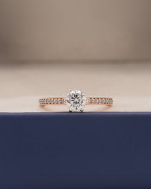 round moissanite pave ring worn on hand in rose gold