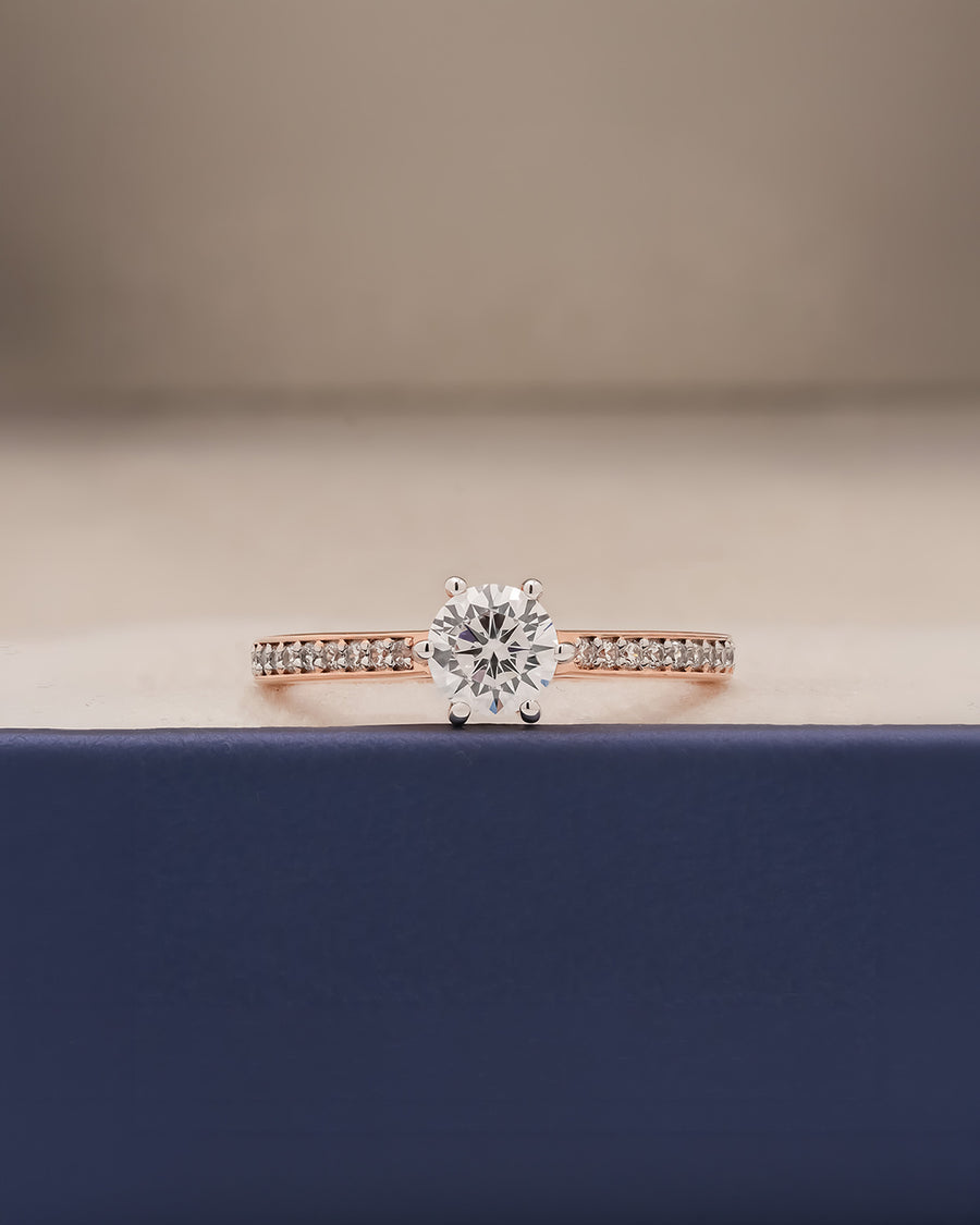 round moissanite pave ring worn on hand in rose gold
