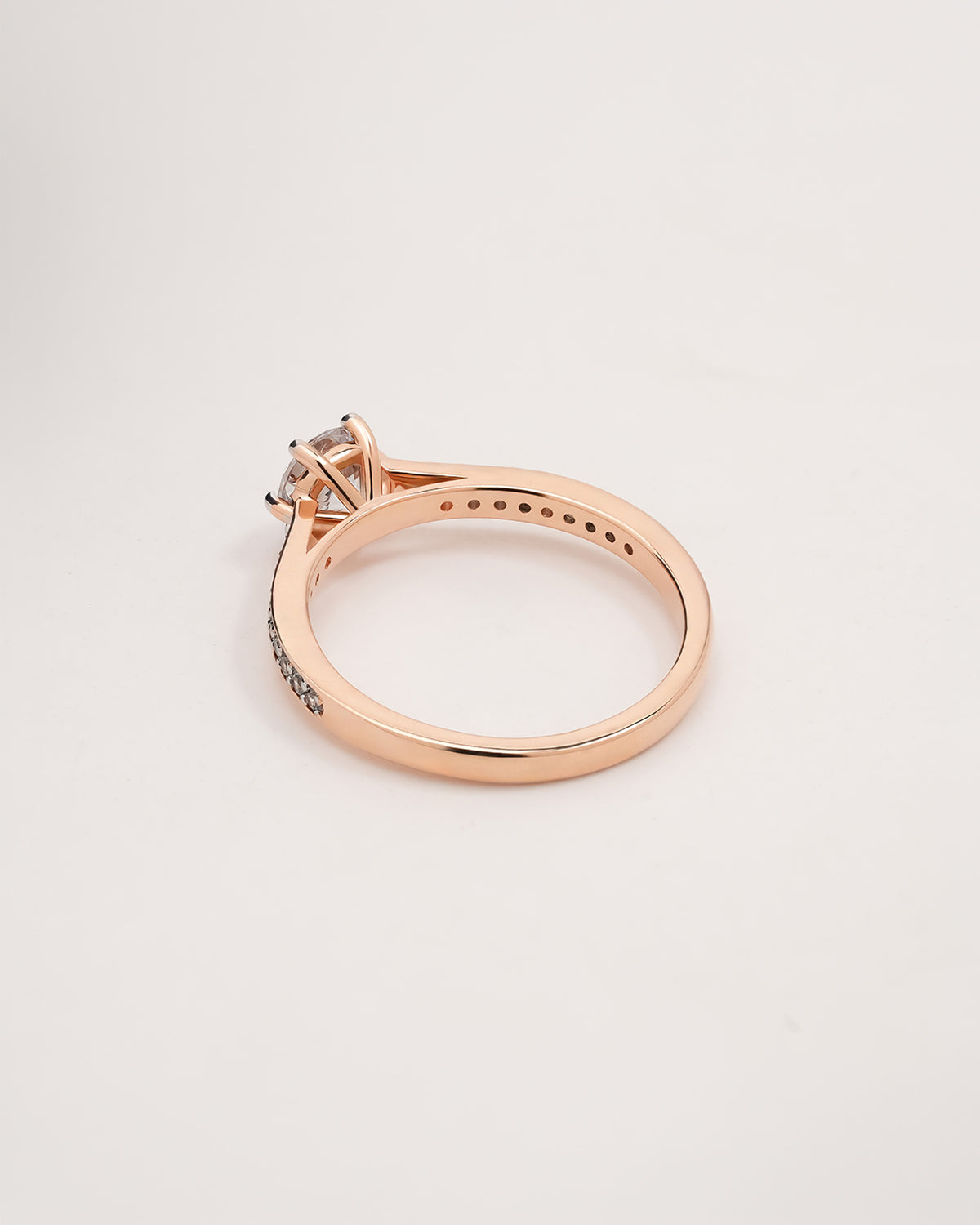 round moissanite pave ring worn with luxury styling in rose gold