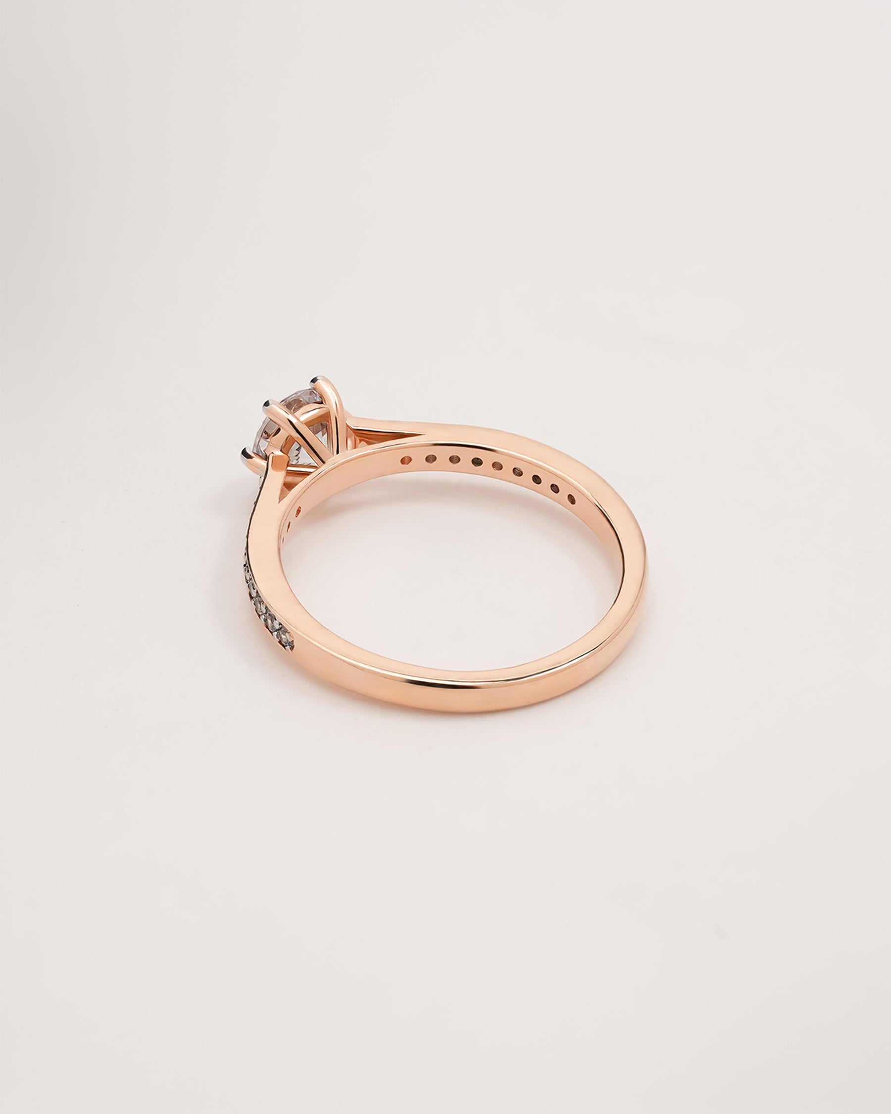 round moissanite pave ring worn with luxury styling in rose gold