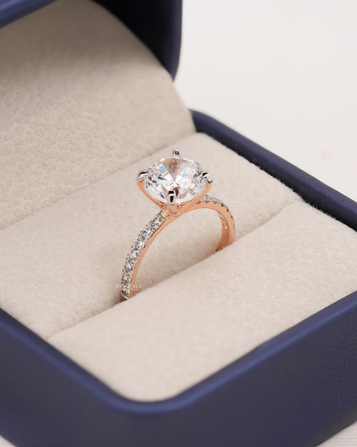 Angled view of round moissanite pave ring with pave setting