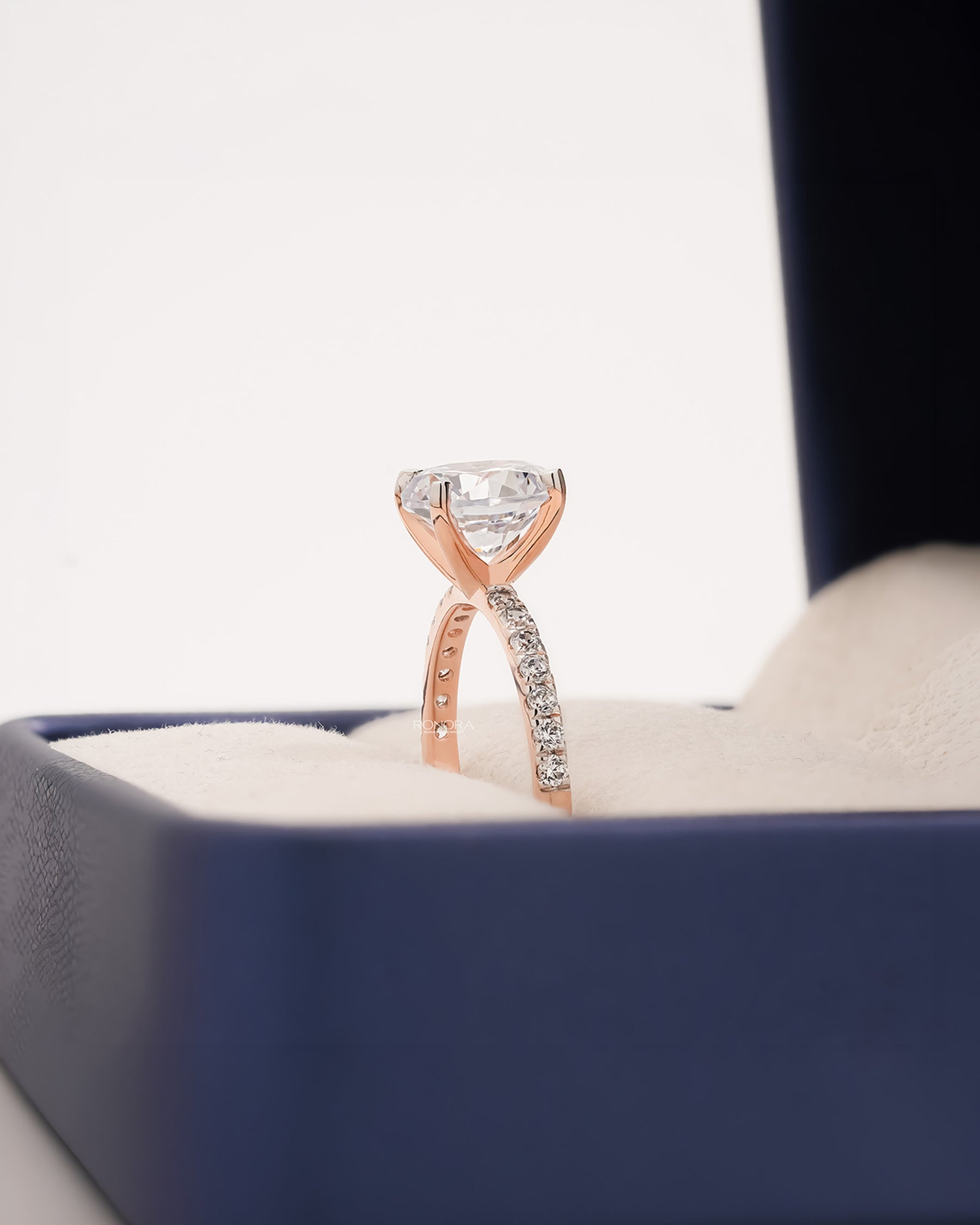 Side profile of round moissanite pave ring showing ring setting