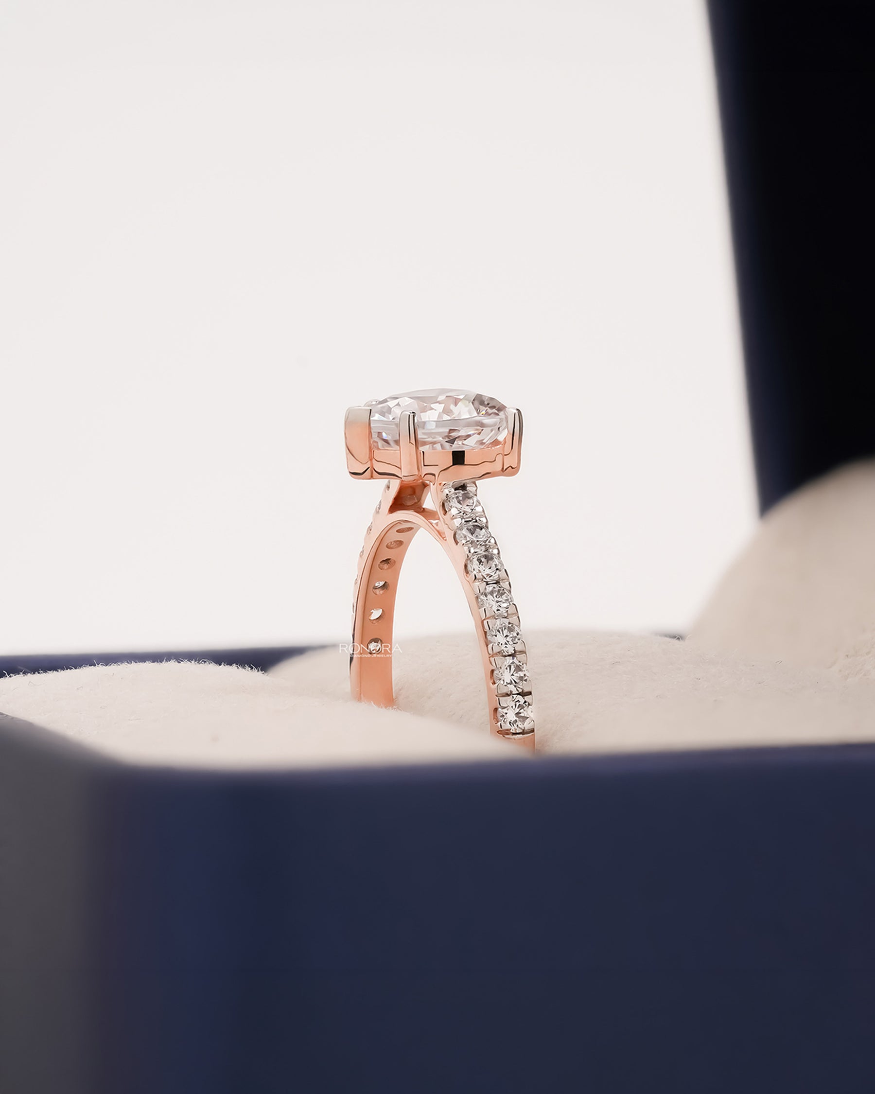 Side profile of heart moissanite pave ring showing ring setting
