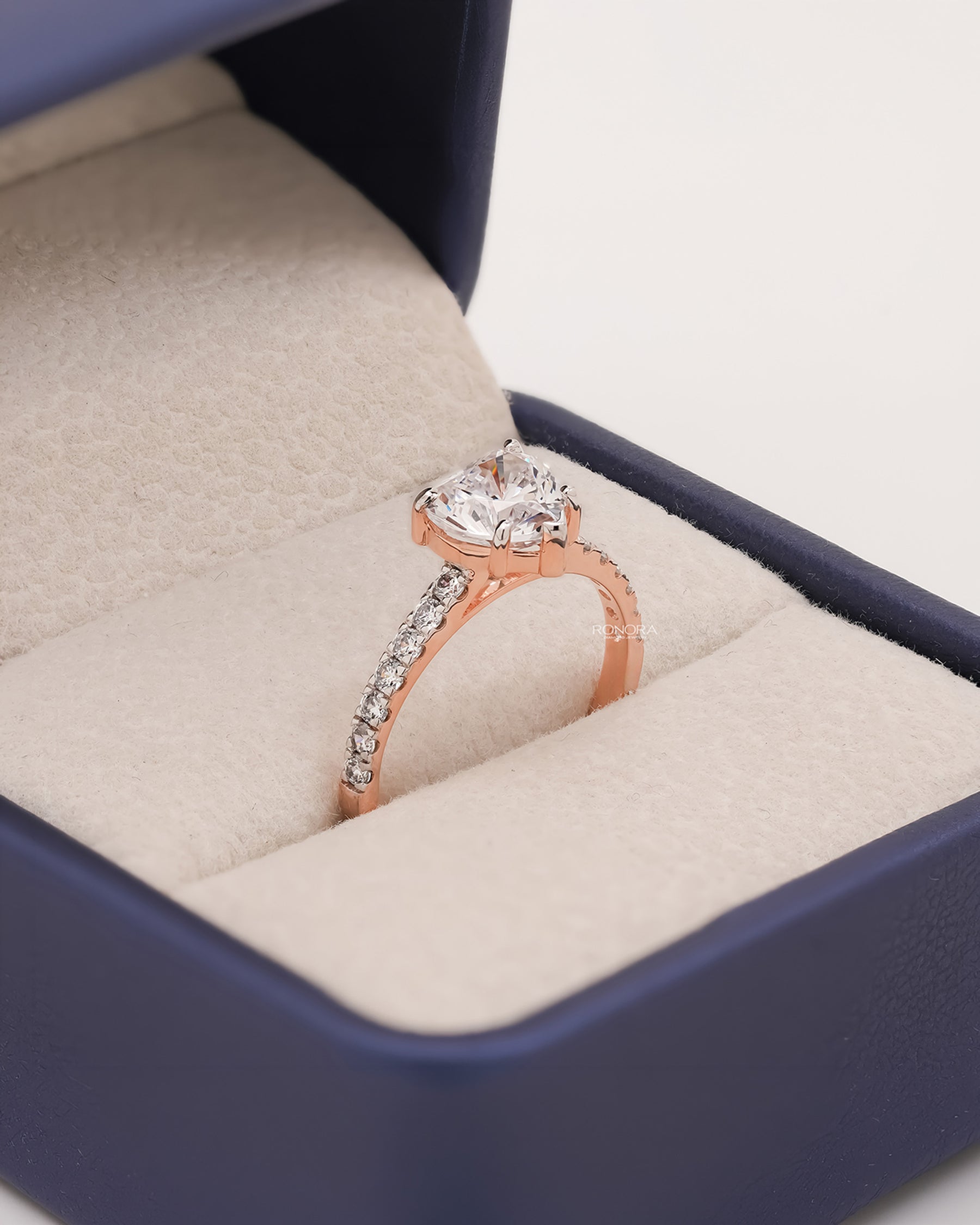 Angled view of heart moissanite pave ring with pave setting