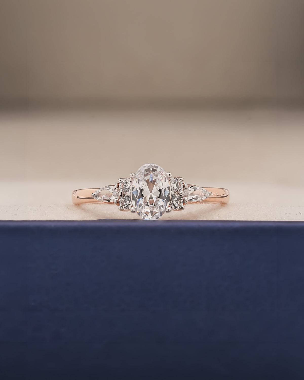 Lisette oval pear moissanite cluster ring in rose gold inside Ronora box