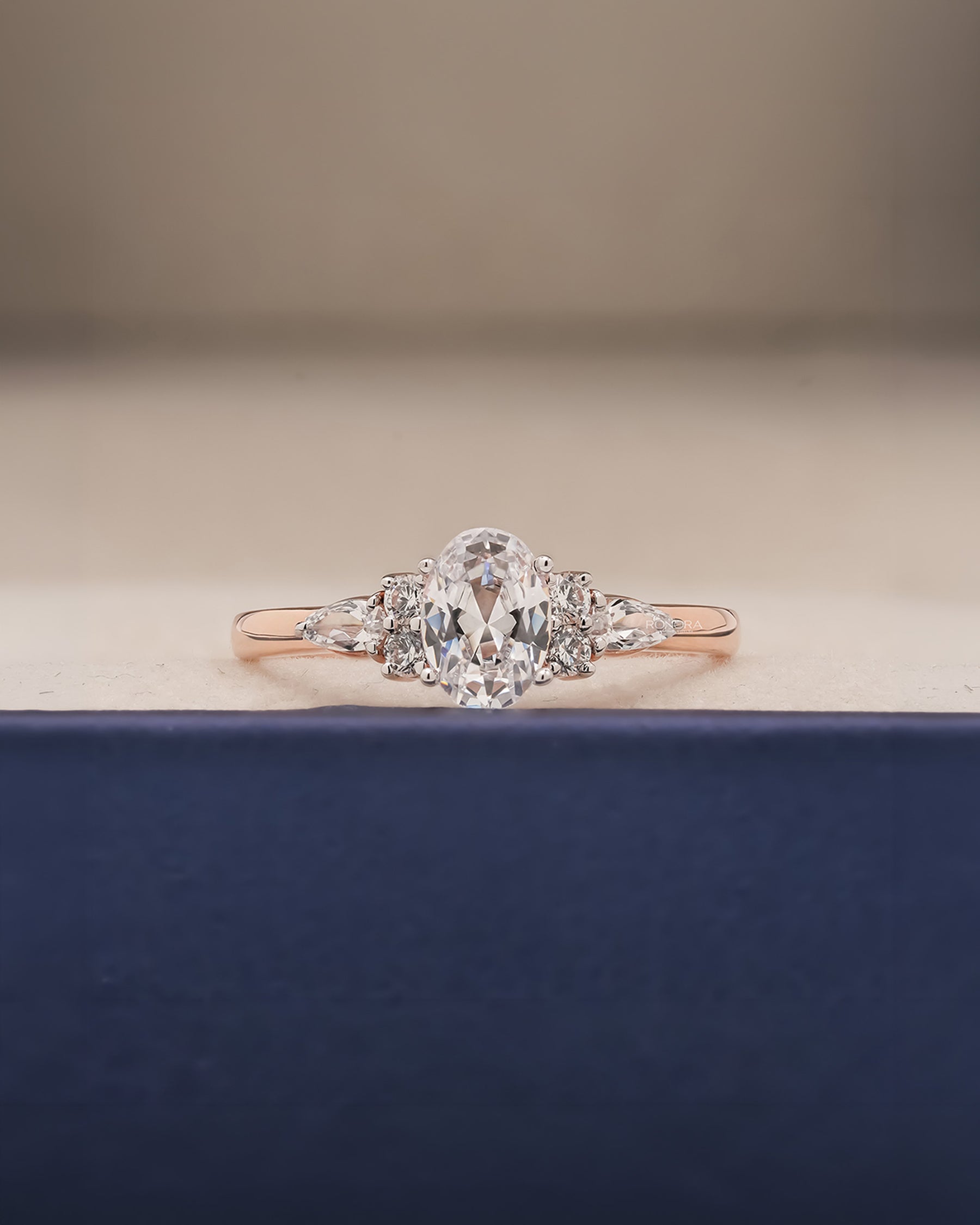 Lisette oval pear moissanite cluster ring in rose gold inside Ronora box