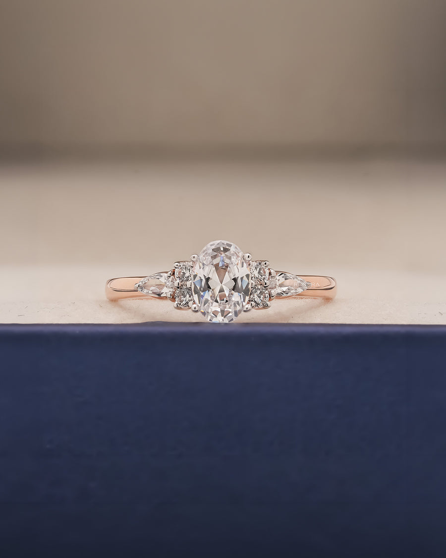 Lisette oval pear moissanite cluster ring in rose gold inside Ronora box
