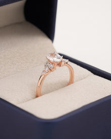 Angled view of oval pear moissanite cluster ring with cluster setting