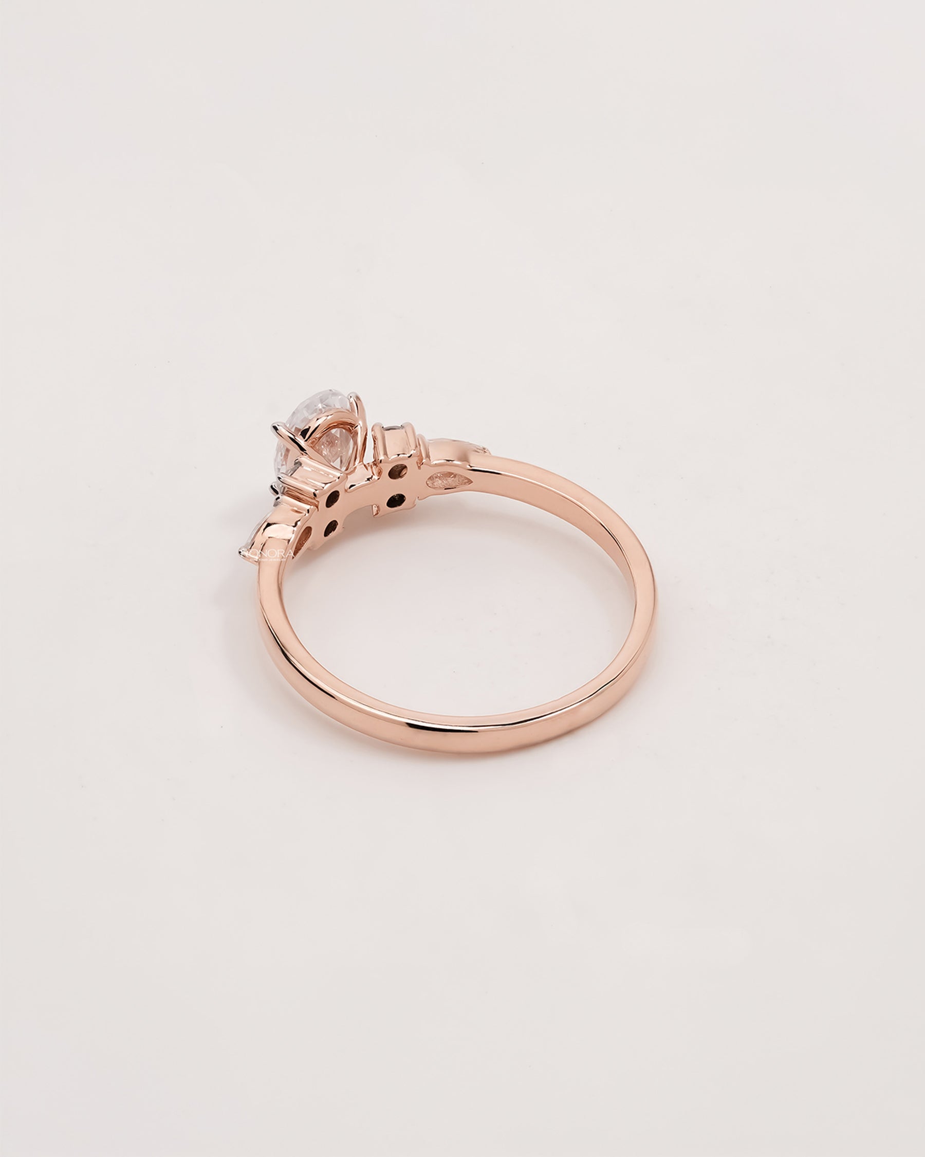 Back view of oval pear moissanite cluster ring showing band detail
