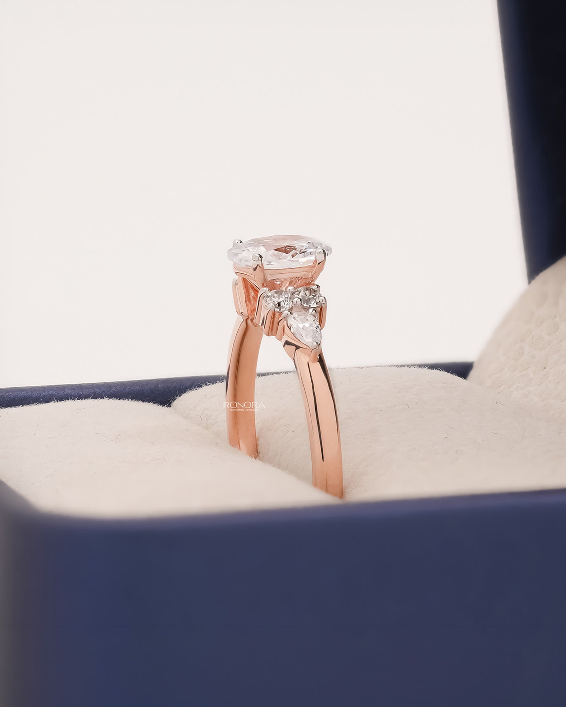 Side profile of oval pear moissanite cluster ring showing ring setting