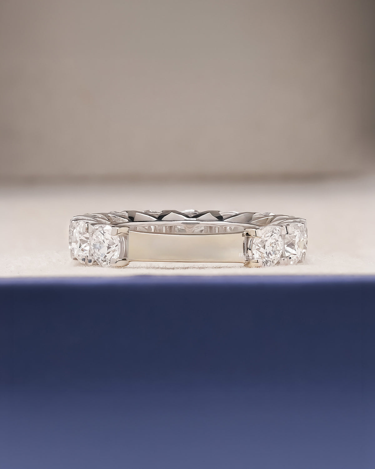 Side profile of round lab grown diamond eternity band showing ring setting