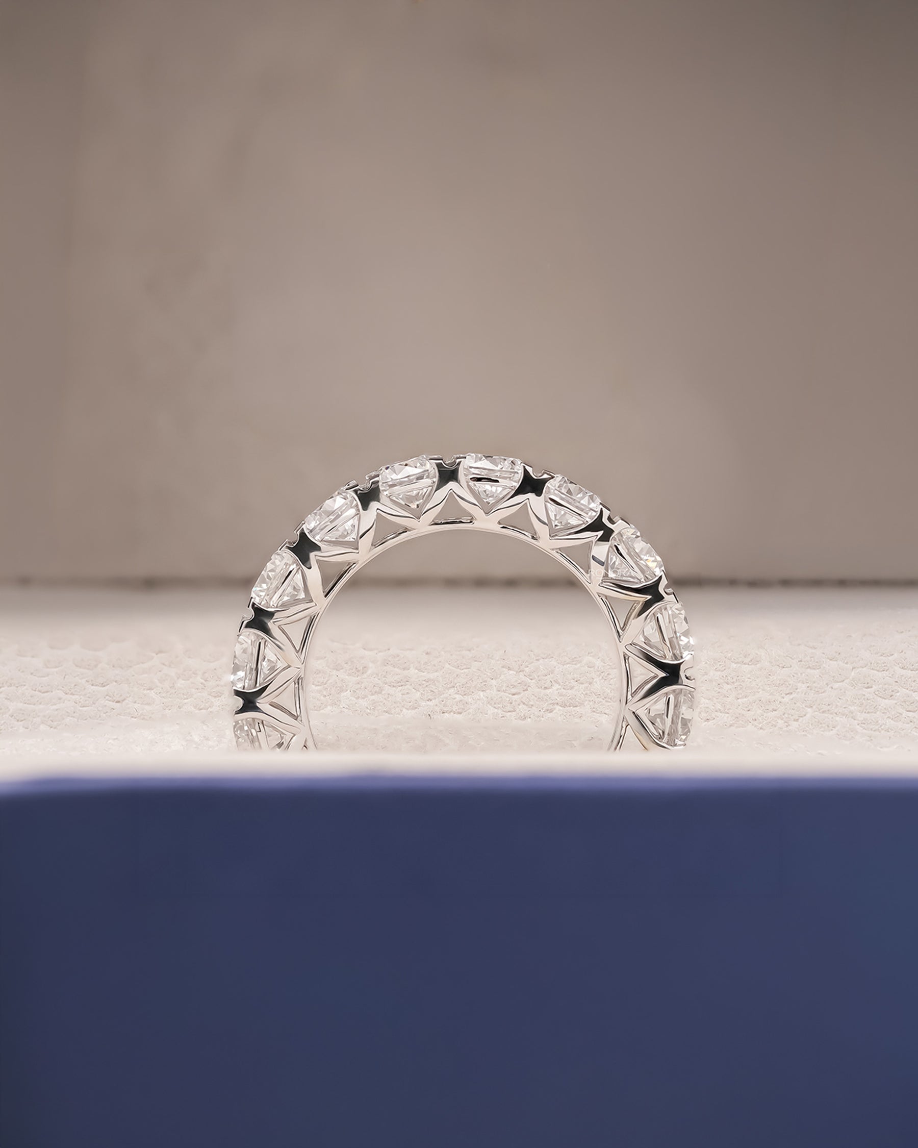Angled view of round lab grown diamond eternity band with eternity setting