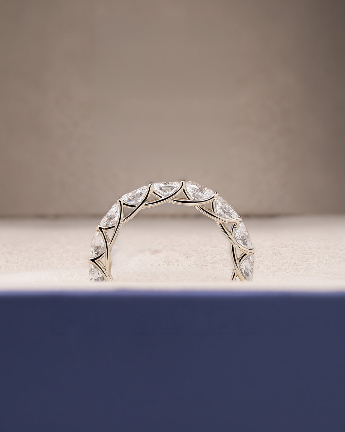 Angled view of oval lab grown diamond eternity band with eternity setting