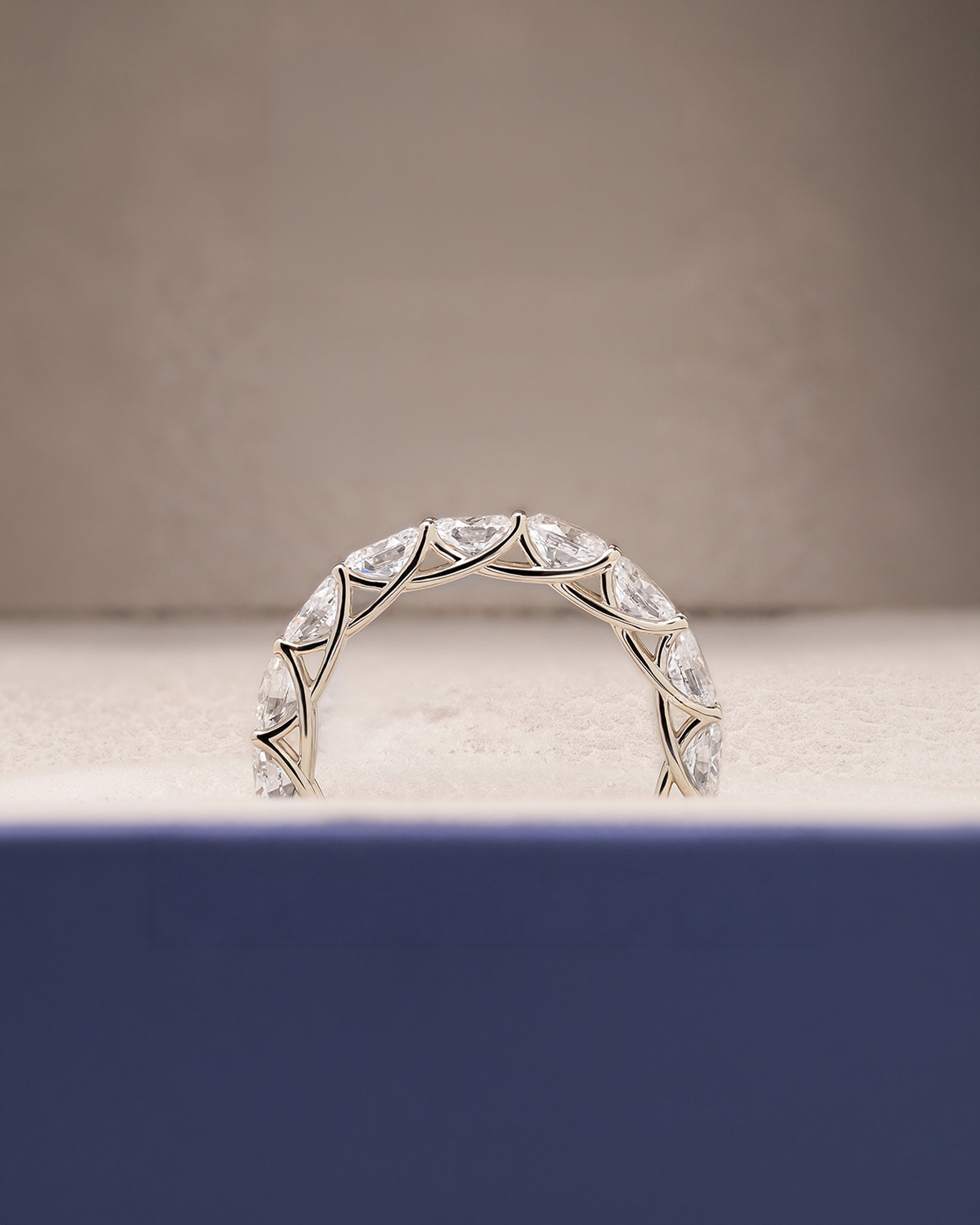 Angled view of oval lab grown diamond eternity band with eternity setting
