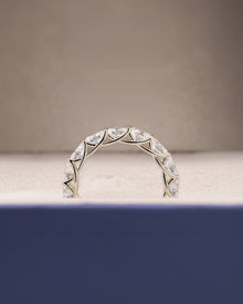 Angled view of oval lab grown diamond eternity band with eternity setting