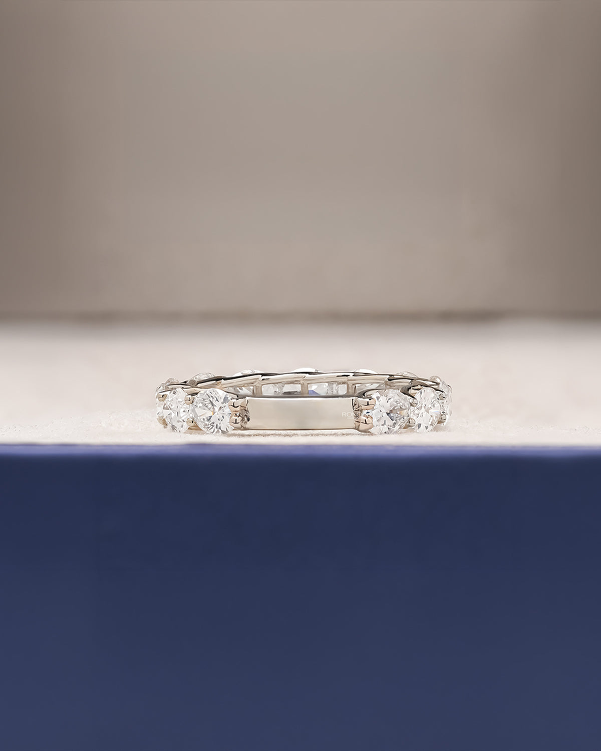 Side profile of oval lab grown diamond eternity band showing ring setting