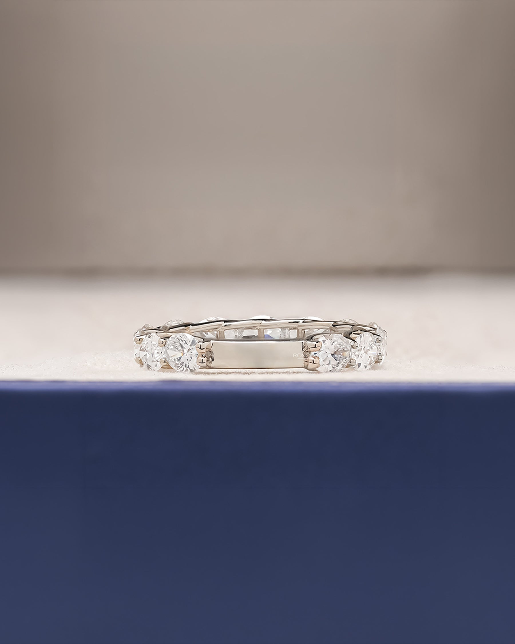 Side profile of oval lab grown diamond eternity band showing ring setting