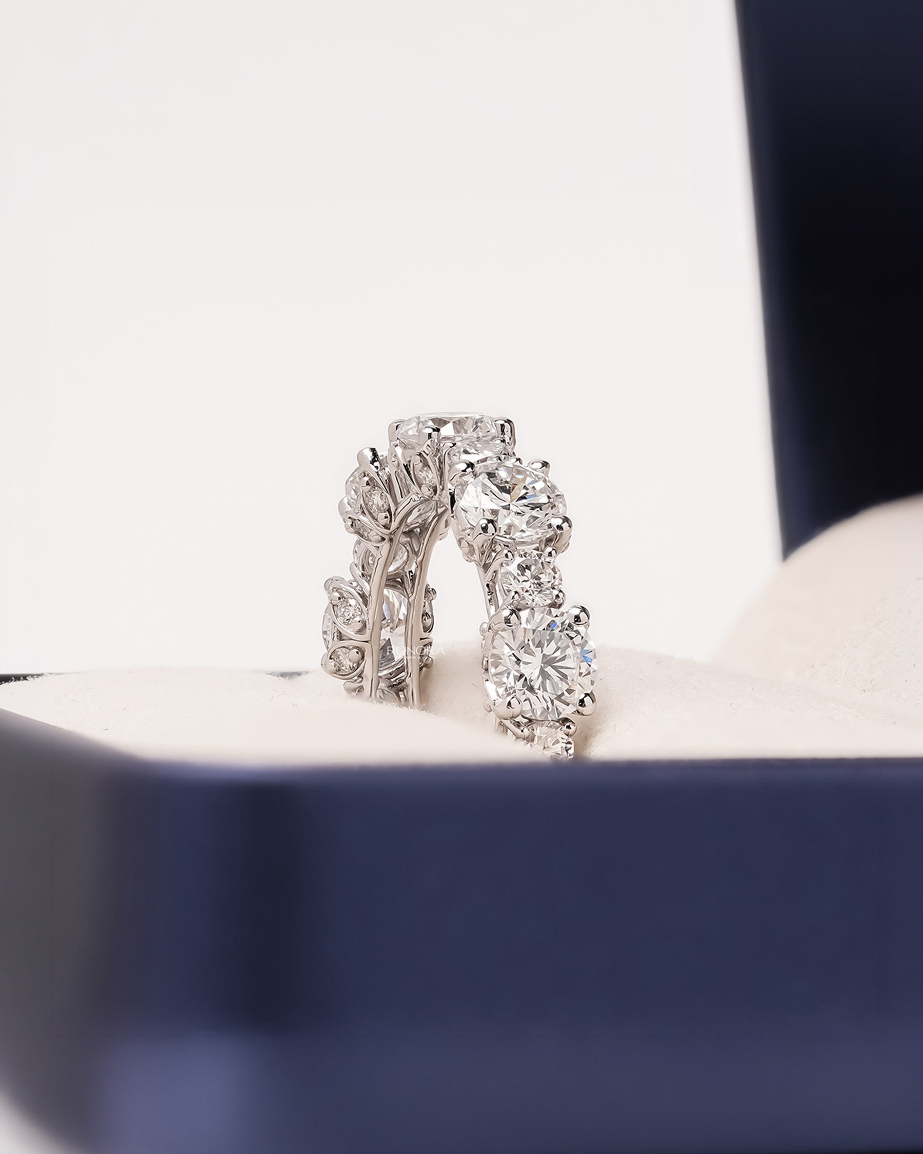 Angled view of round lab grown diamond eternity band with eternity setting