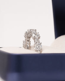 Angled view of round lab grown diamond eternity band with eternity setting