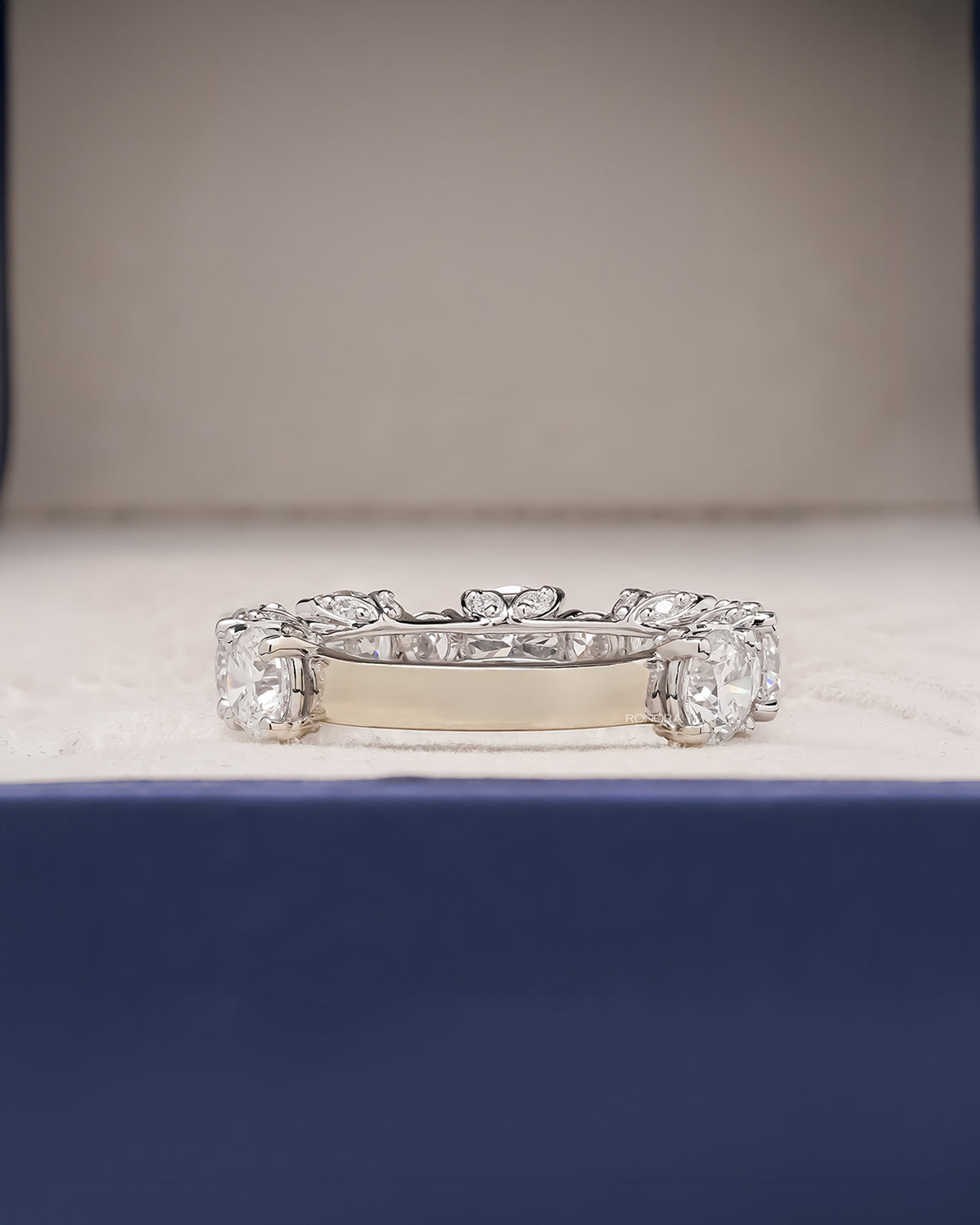round lab grown diamond eternity band worn on hand in white gold