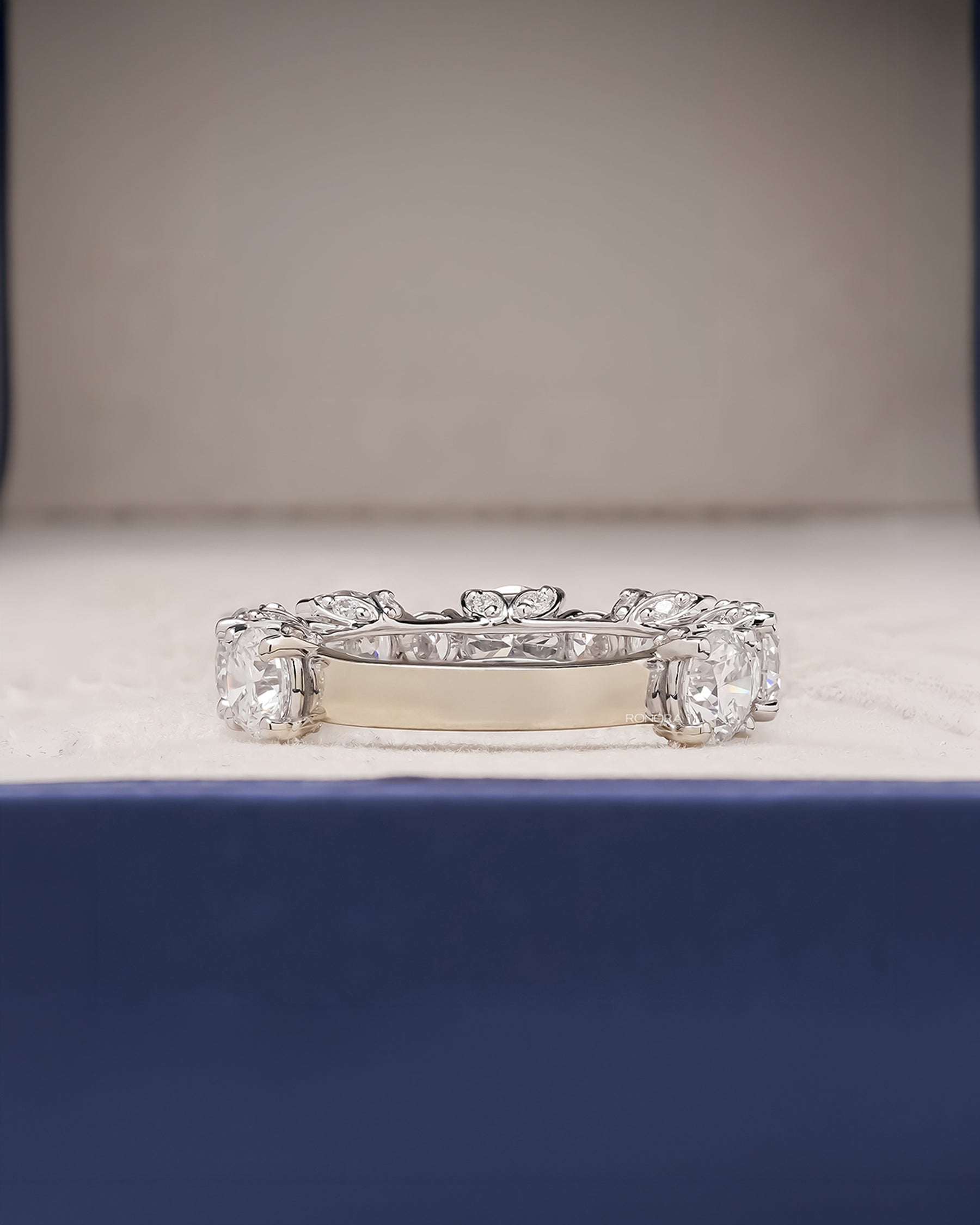 round lab grown diamond eternity band worn on hand in white gold