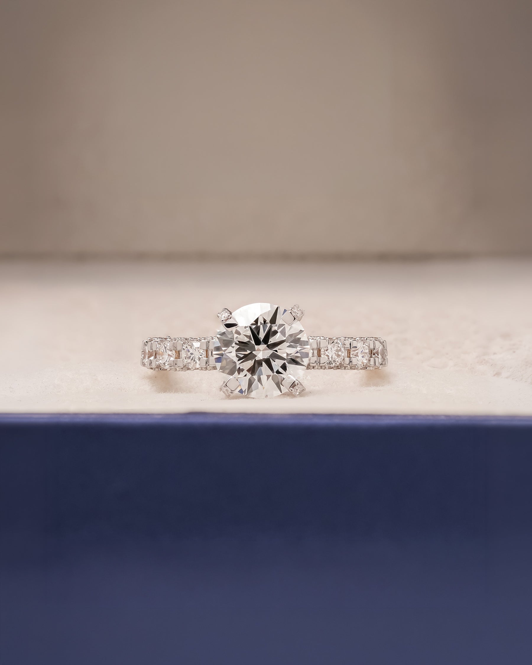 Nadia round lab grown diamond side-stone ring in white gold inside Ronora box