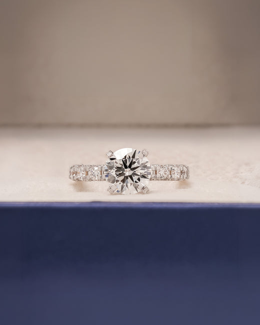 Nadia round lab grown diamond side-stone ring in white gold inside Ronora box