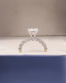 Angled view of round lab grown diamond side-stone ring with side-stone setting