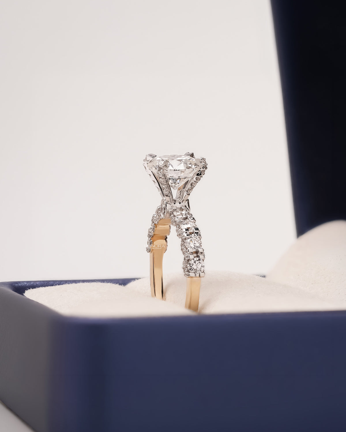 Side profile of round lab grown diamond side-stone ring showing ring setting
