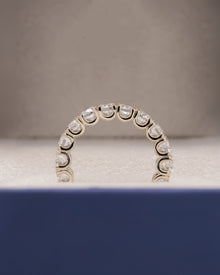 Angled view of round lab grown diamond eternity band with eternity setting