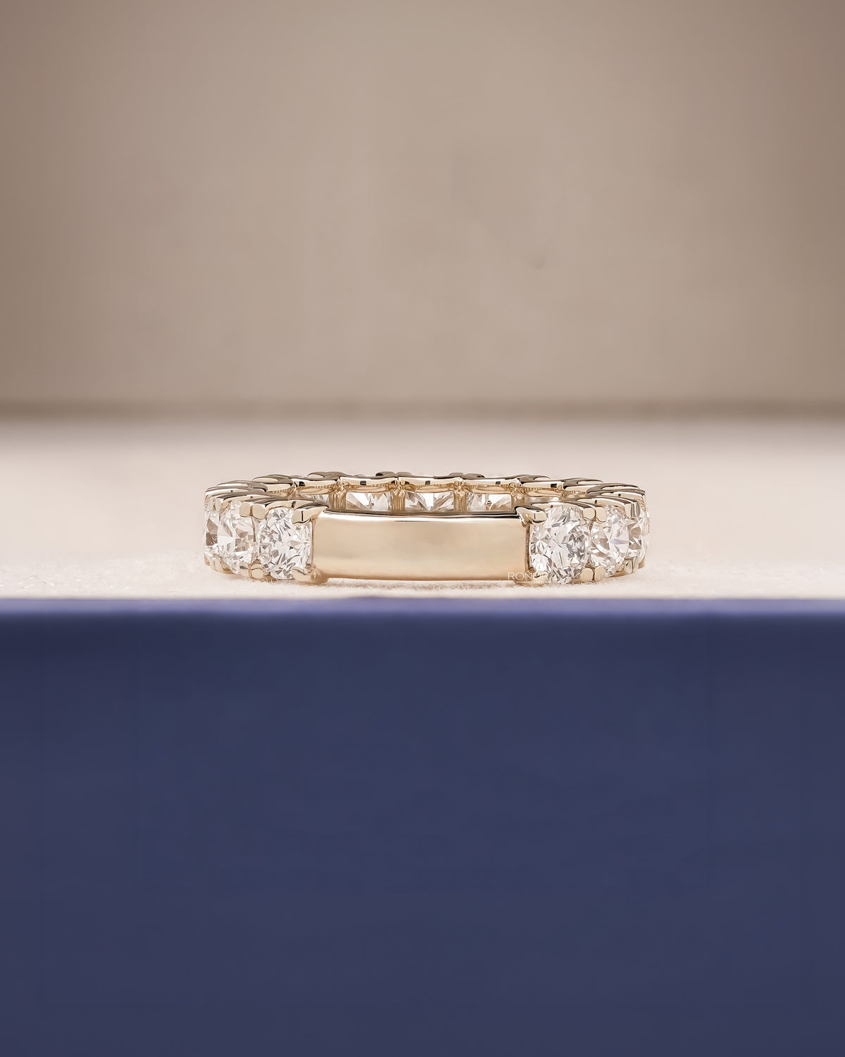 Side profile of round lab grown diamond eternity band showing ring setting