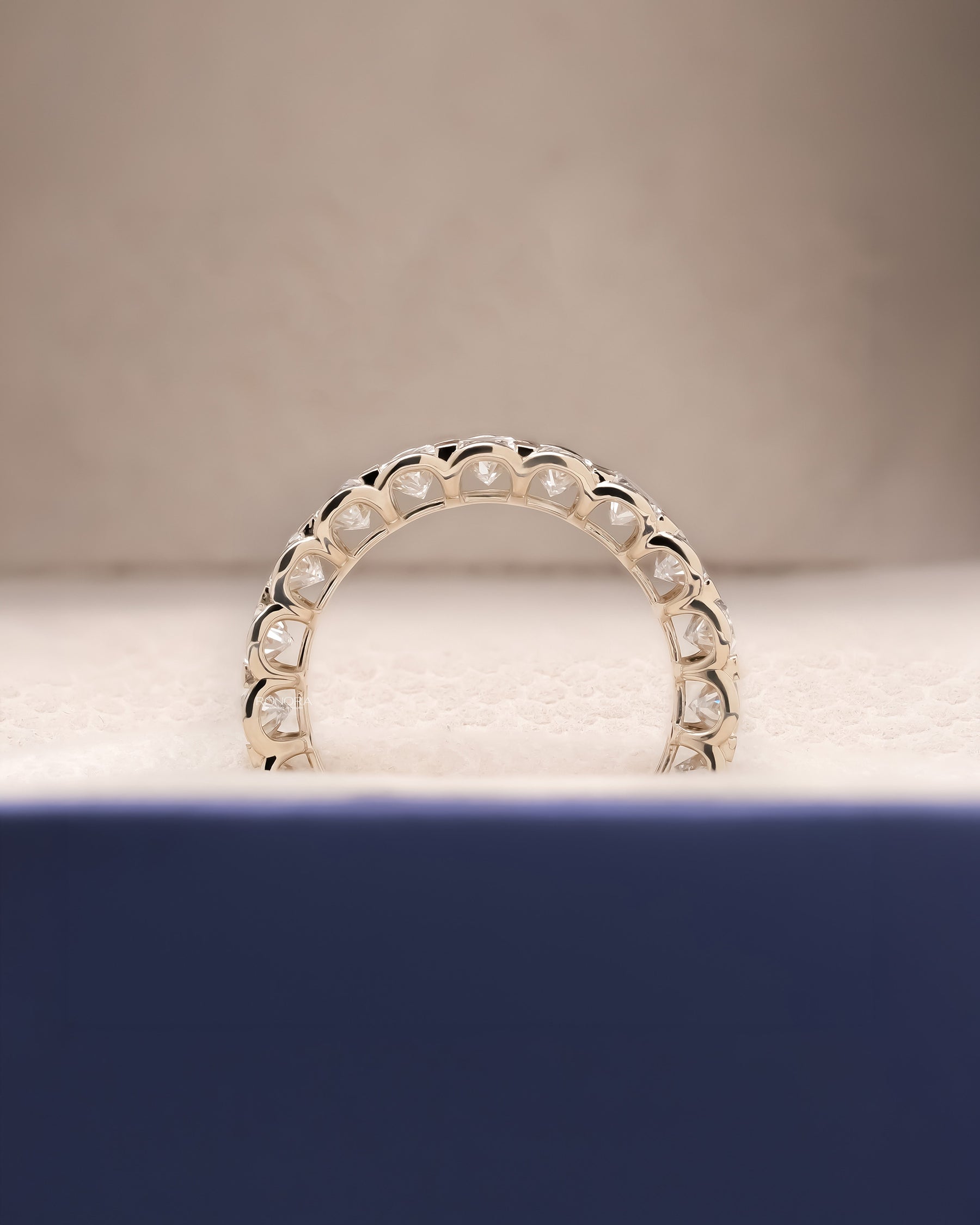 Angled view of oval lab grown diamond eternity band with eternity setting